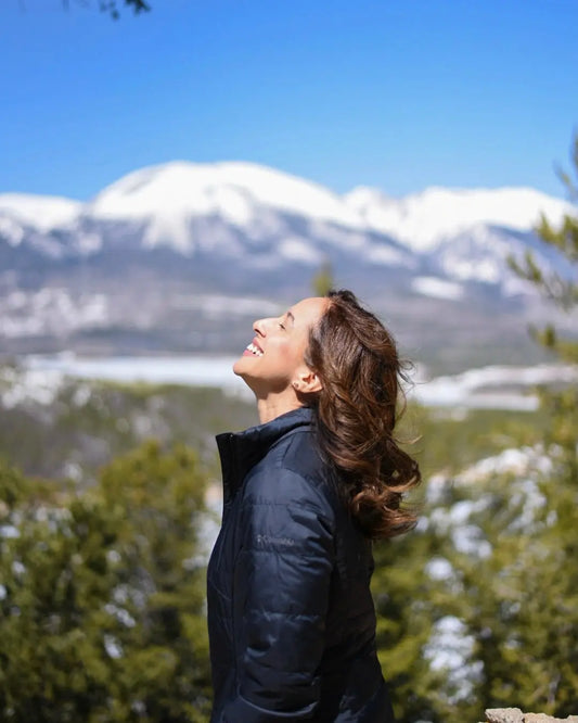colorado mountain range and lady looking up