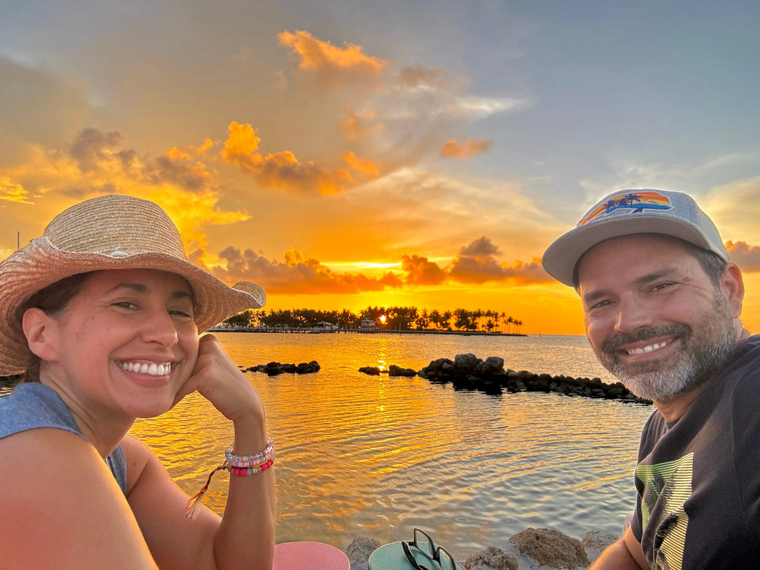 two people watching florida sunset by the water