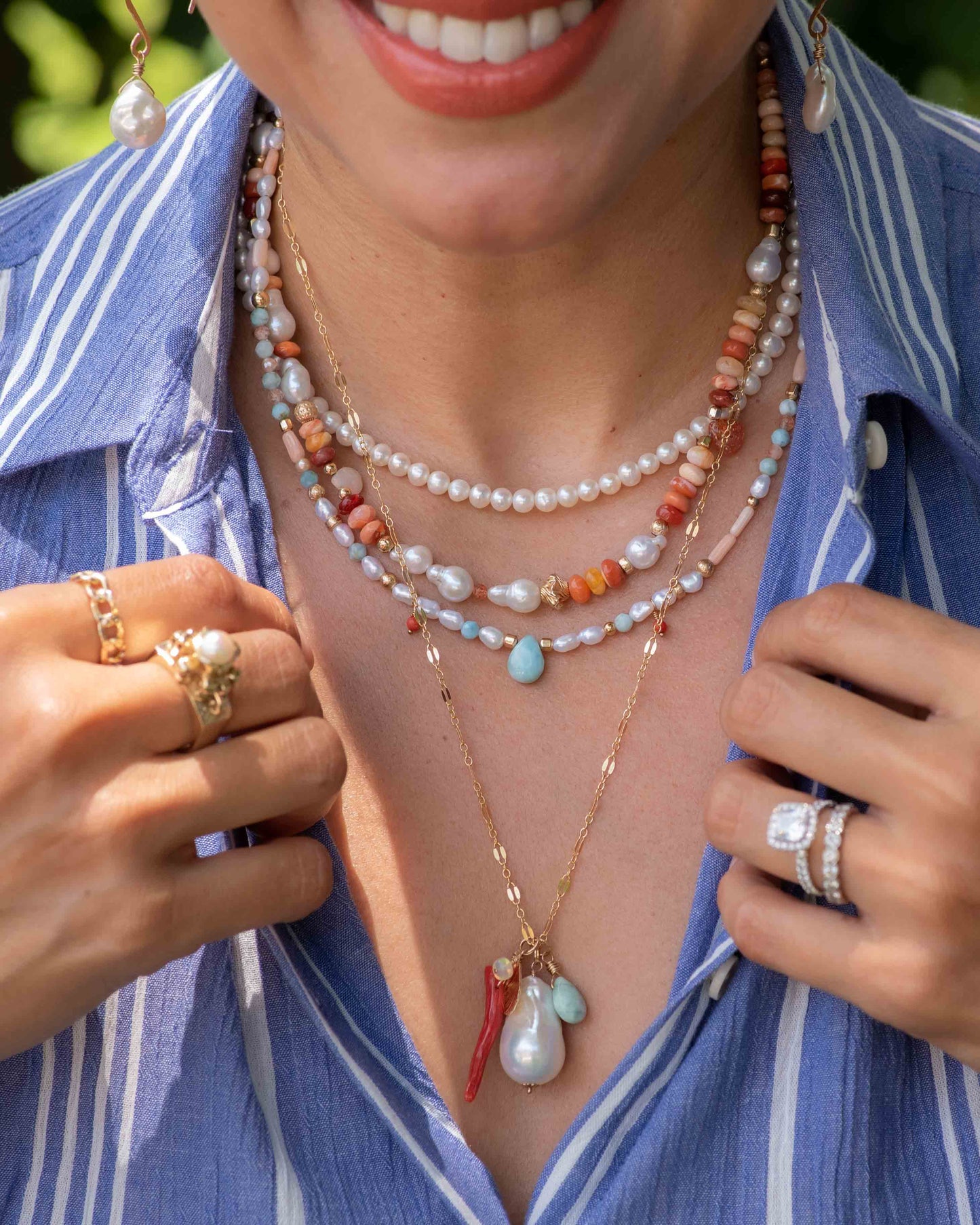 multiple pearl and gemstone necklaces layered